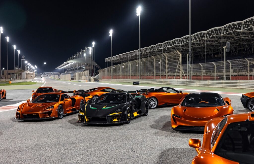 Modern McLaren road cars in Mansour Orange lined up on circuit