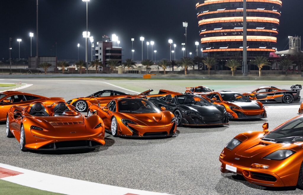 Modern McLaren road cars in Mansour Orange lined up on circuit