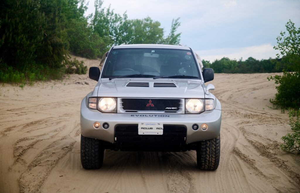 Mitsubishi Pajero Evolution driving through sand dunes during off-road test