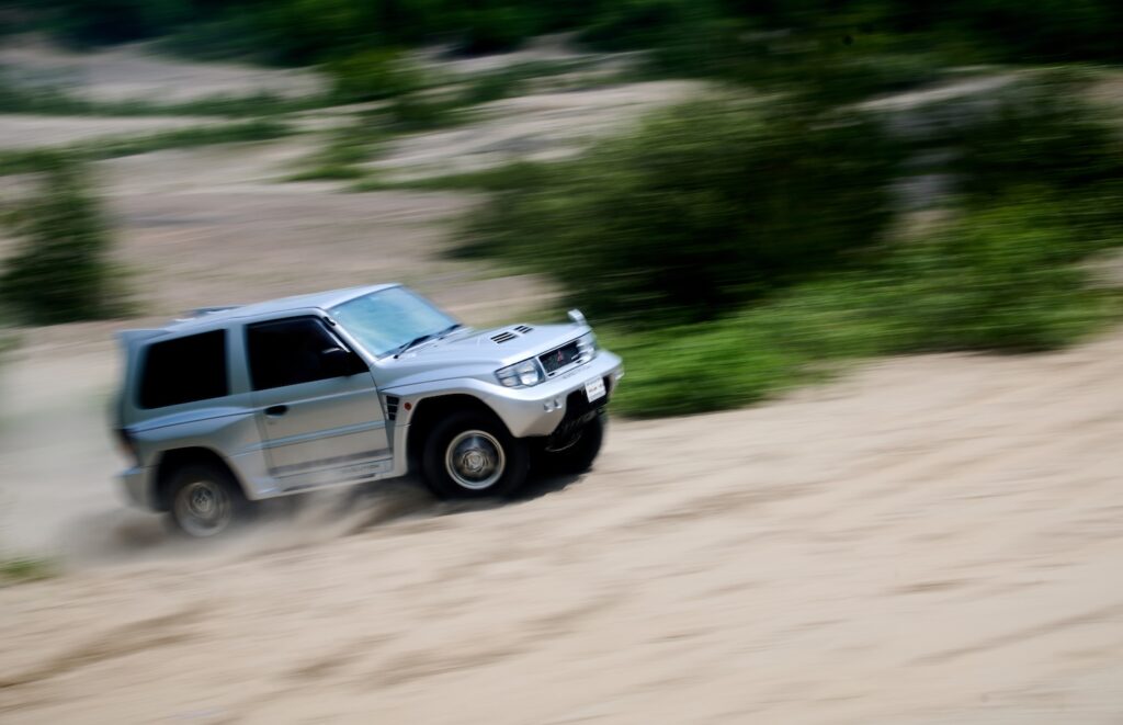 Mitsubishi Pajero Evolution driving through sand dunes during off-road test