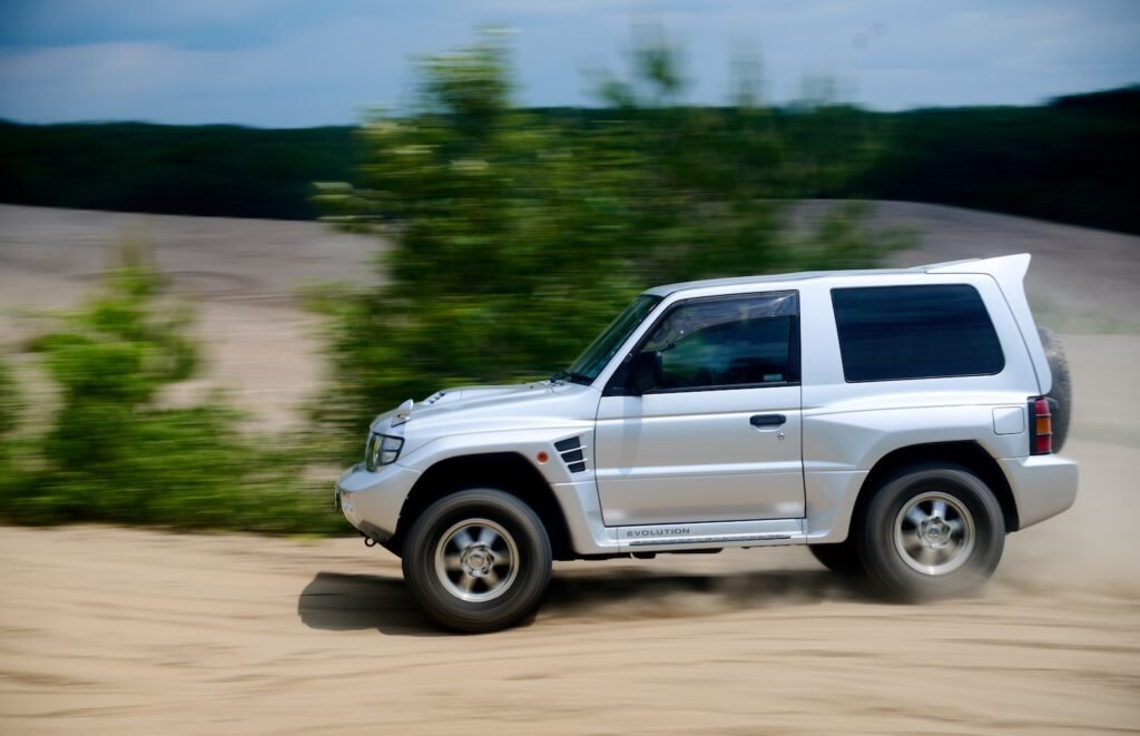 Mitsubishi Pajero Evolution driving through sand dunes during off-road test