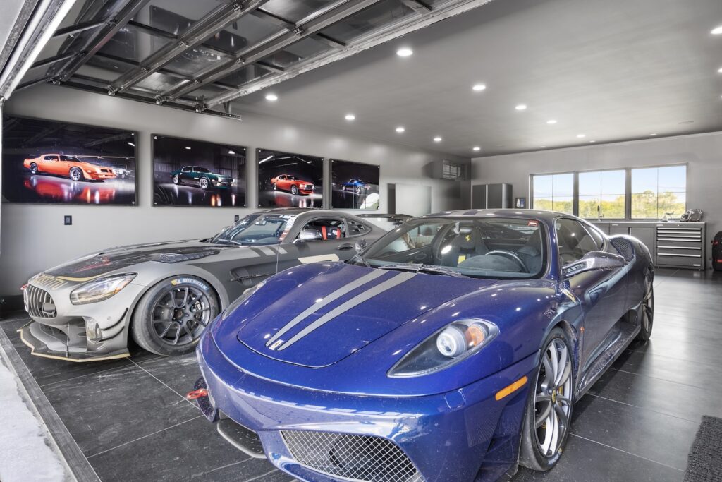 Luxury garage interior with Ferrari and Mercedes-AMG performance cars parked side by side