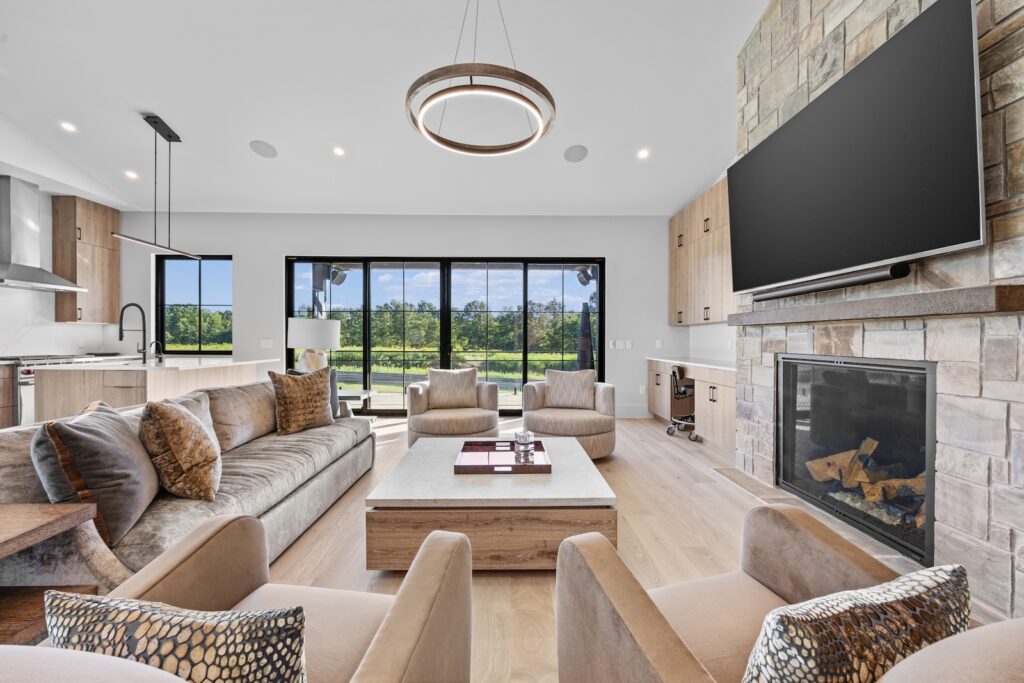 Luxury clubhouse living room with fireplace and racetrack views through large windows
