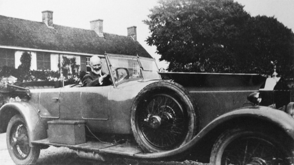 Henry Royce driving an early Rolls-Royce motor car near his home in West Wittering