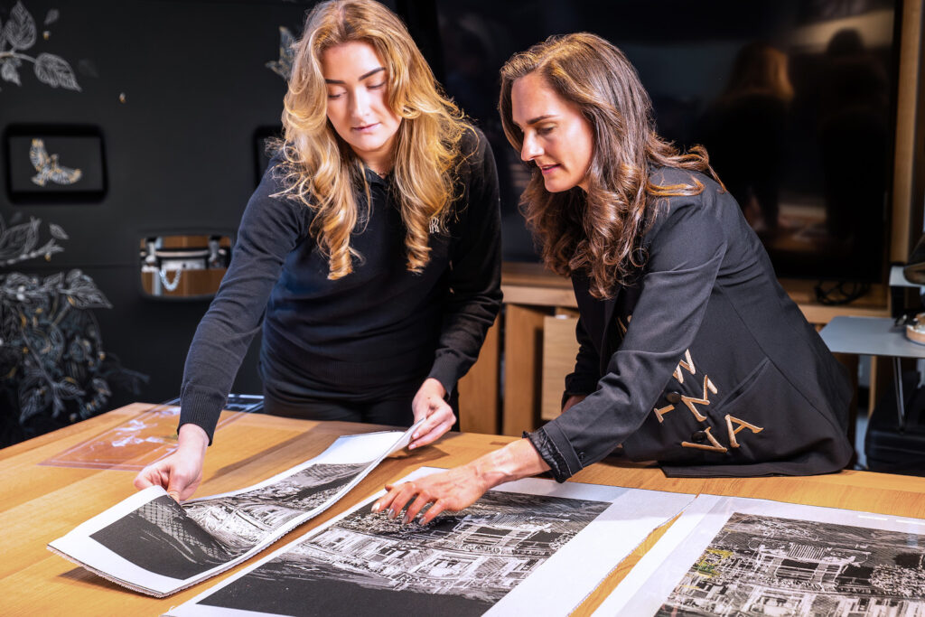 Designers reviewing bespoke Rolls-Royce couture fabric panels on a studio table