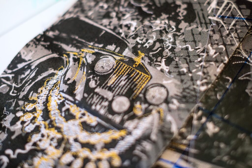 Embroidered Rolls-Royce Phantom motif stitched in gold and silver thread