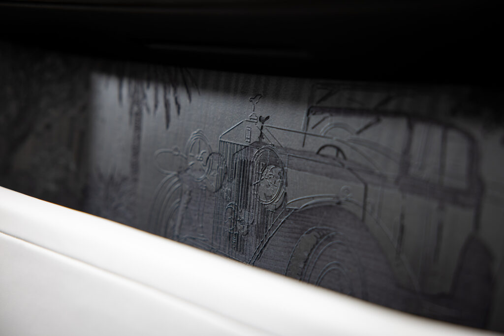 Embossed Phantom illustration subtly carved into dark wood veneer surface