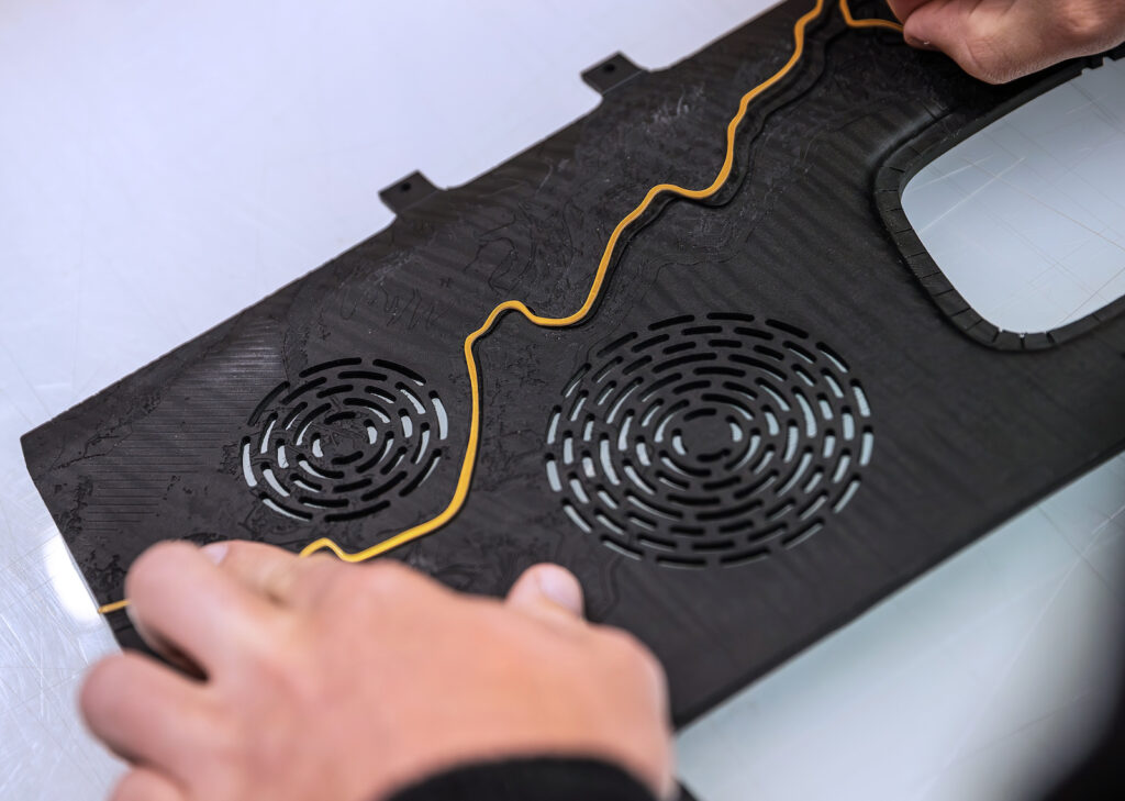 Wide view of complex wood trim panel with integrated gold design line