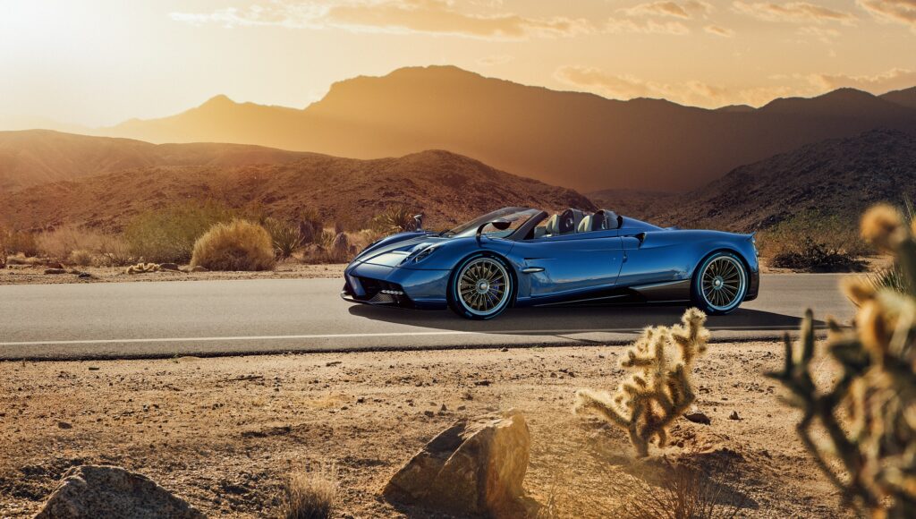 Blue Pagani Huayra Roadster parked in desert landscape