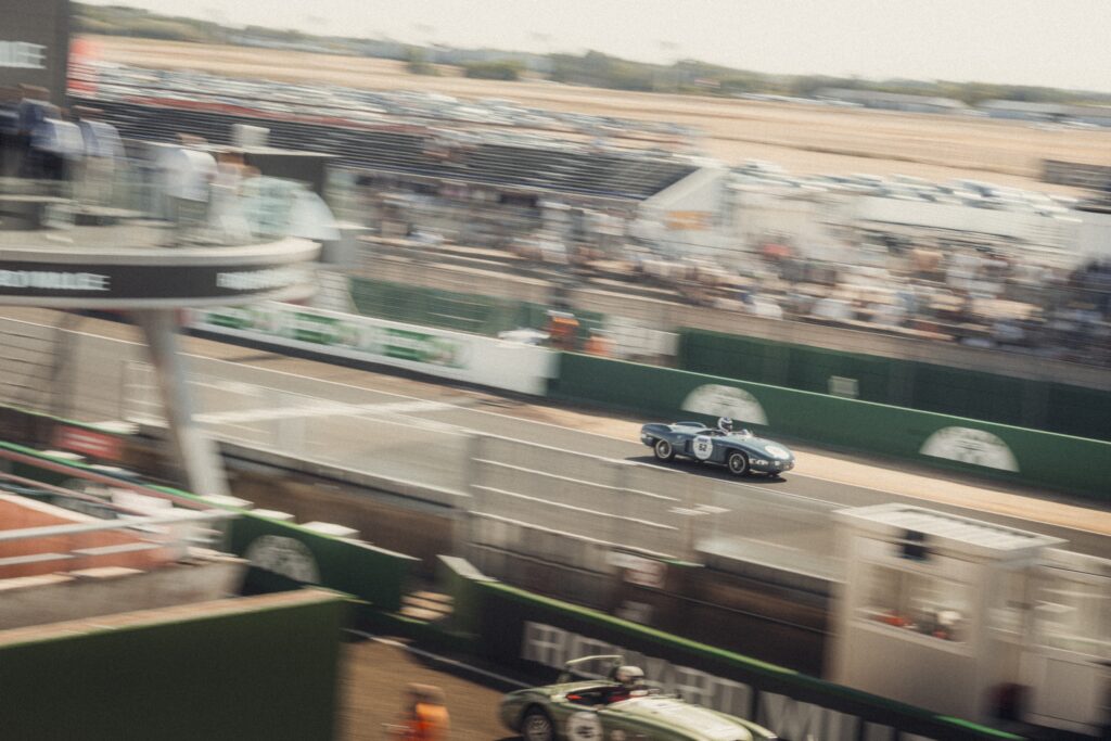 Blue vintage race car crossing the straight at Peter Auto Classic Le Mans