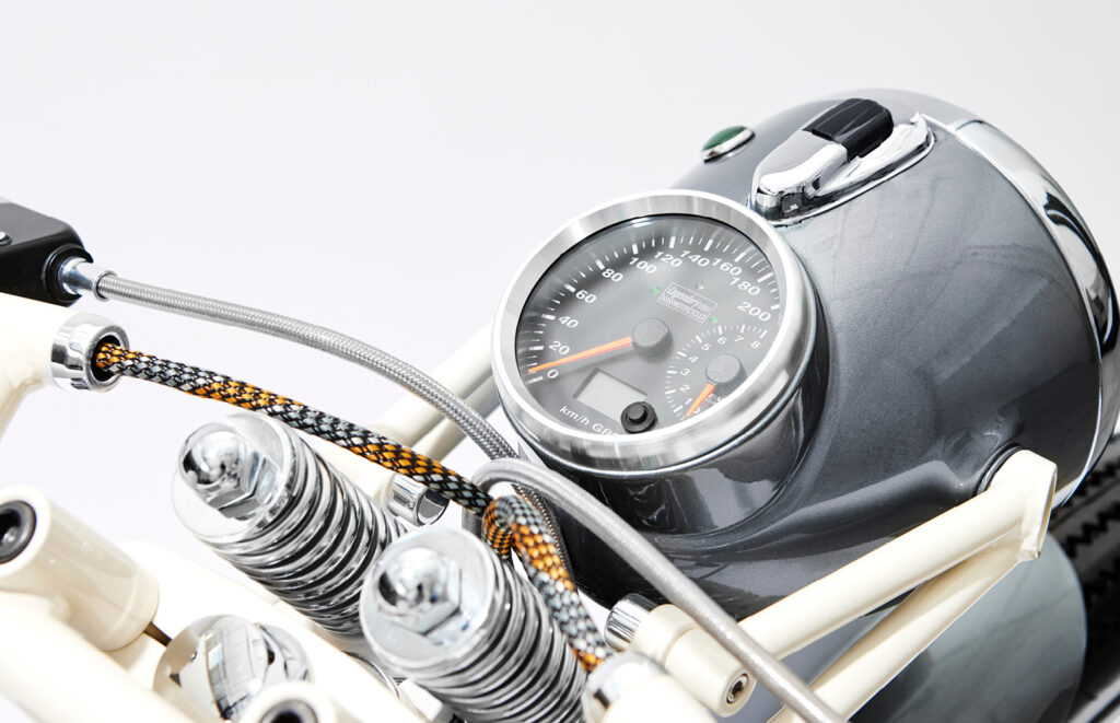 Close-up of integrated speedometer mounted within the fuel tank nacelle on the custom BMW R75/5.