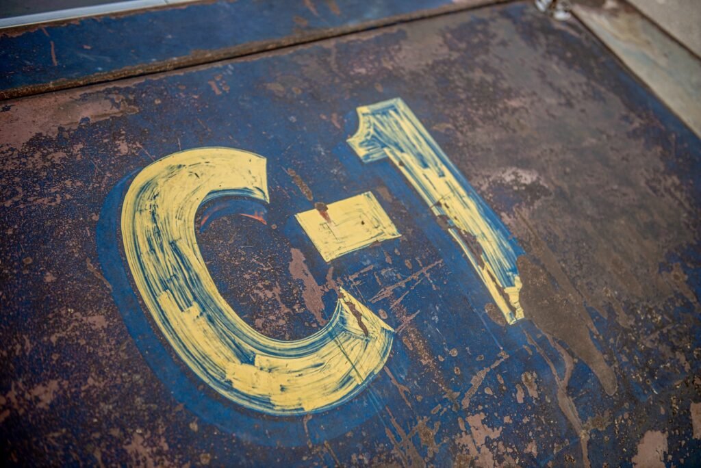 Hand-painted C-1 racing number on weathered 1968 Chevrolet Chevelle door