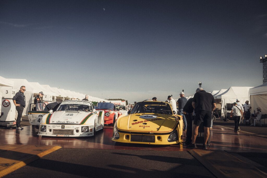 Classic race cars lined up in the paddock at Peter Auto Classic Le Mans