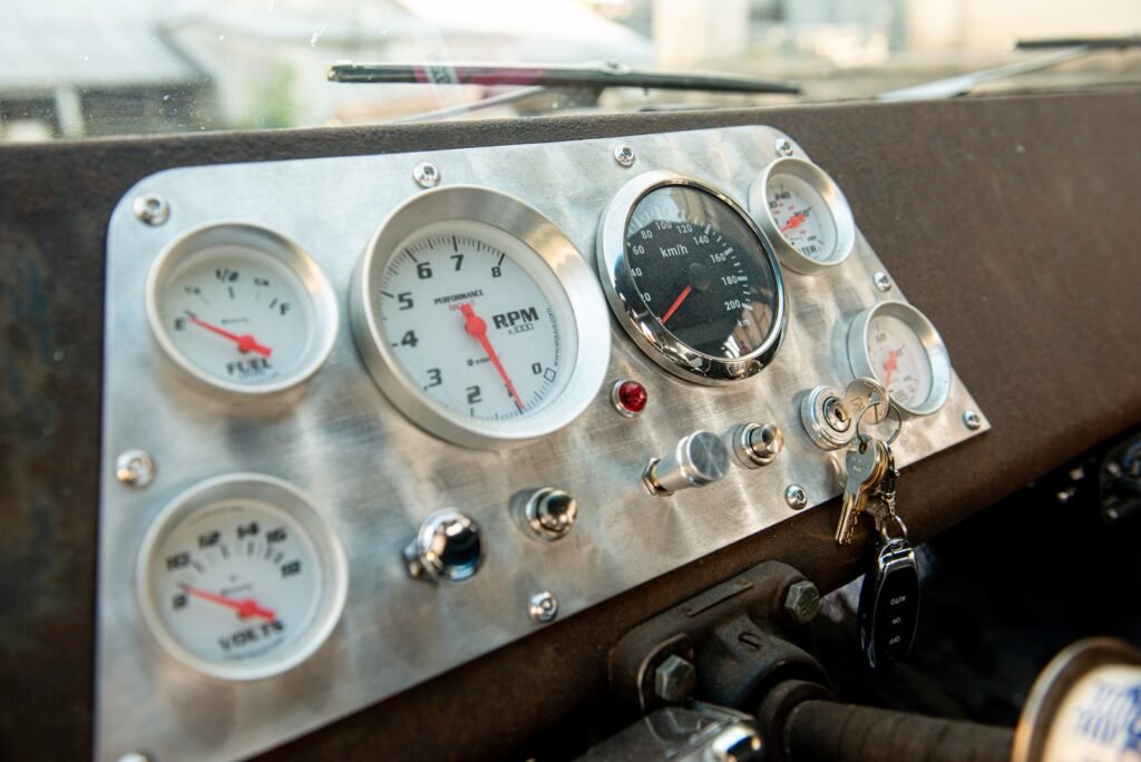 Aftermarket gauge cluster mounted in custom metal dashboard of 1968 Chevelle