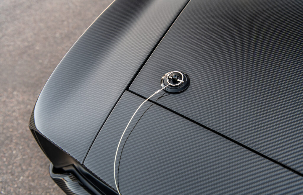 Close-up of carbon fiber hood and flush-mounted hood pin on 1969 Camaro restomod