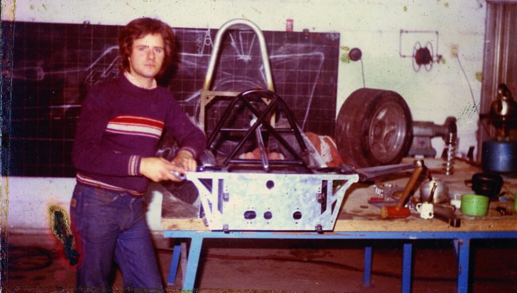 Horacio Pagani working on race car chassis in workshop