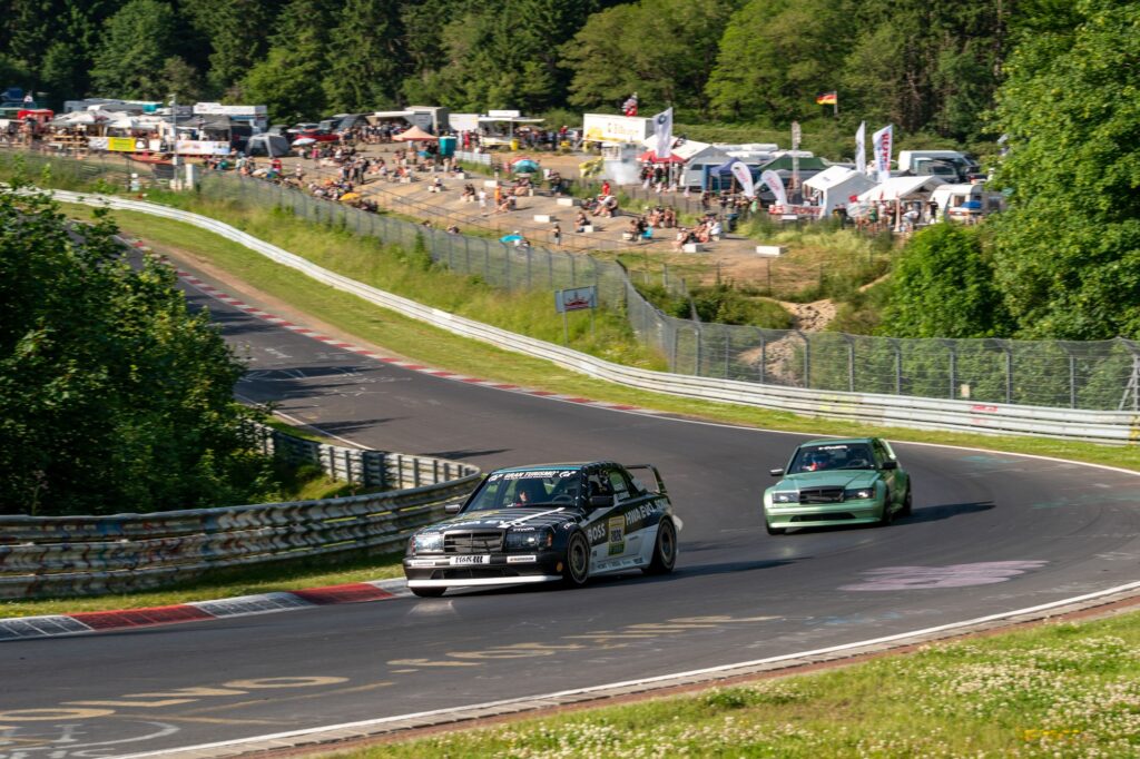 HWA EVO and Mercedes 190E cornering on race circuit
