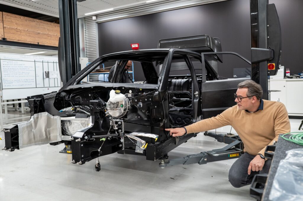 HWA EVO bare body shell with engineer in workshop