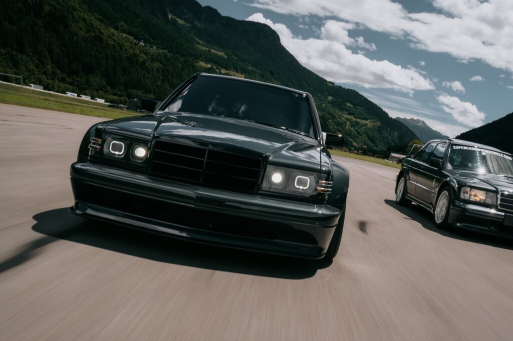 HWA EVO driving on road with second car front three-quarter