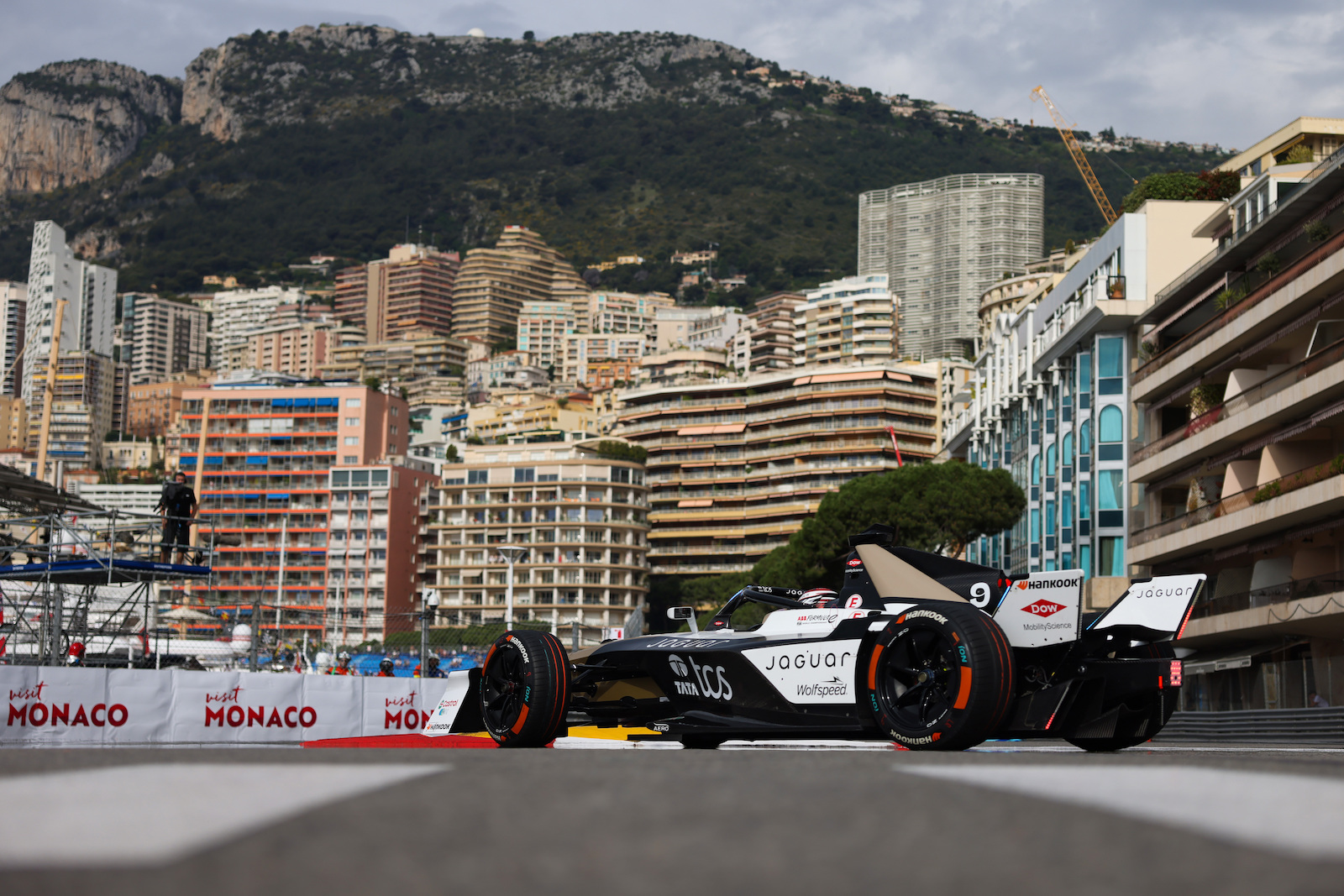 Close-up of Mitch Evans seated in Jaguar Formula E car in Tokyo garage 2025