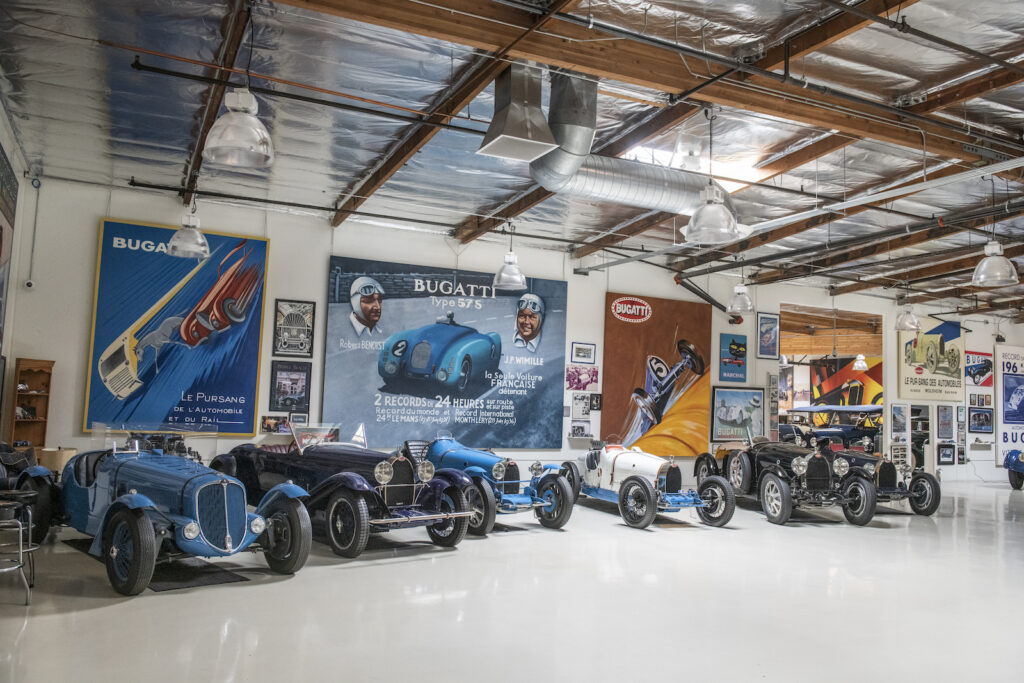 Wide view of blue vintage cars in Jay Leno garage
