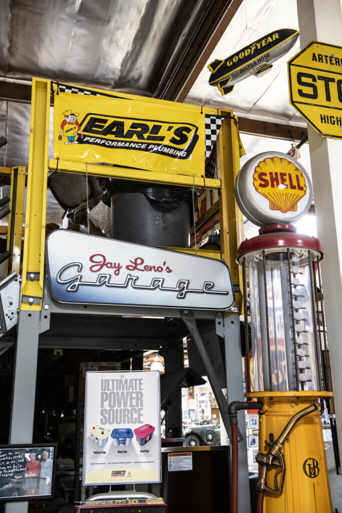 Vintage gas pumps and signage in Jay Leno garage