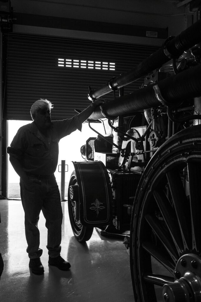 Silhouette beside vintage car in Jay Leno garage