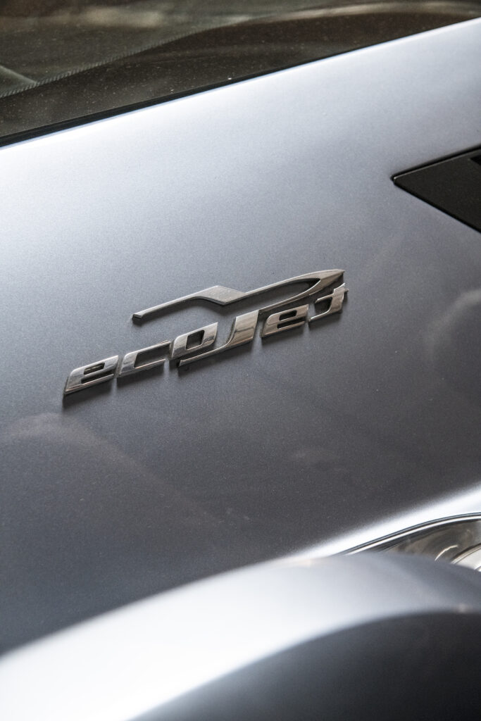 Silver car badge detail in Jay Leno garage