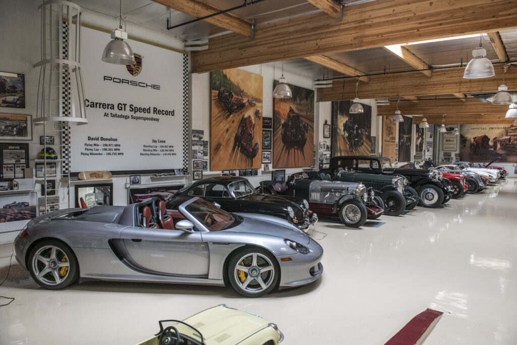 Silver vintage roadster display in Jay Leno garage
