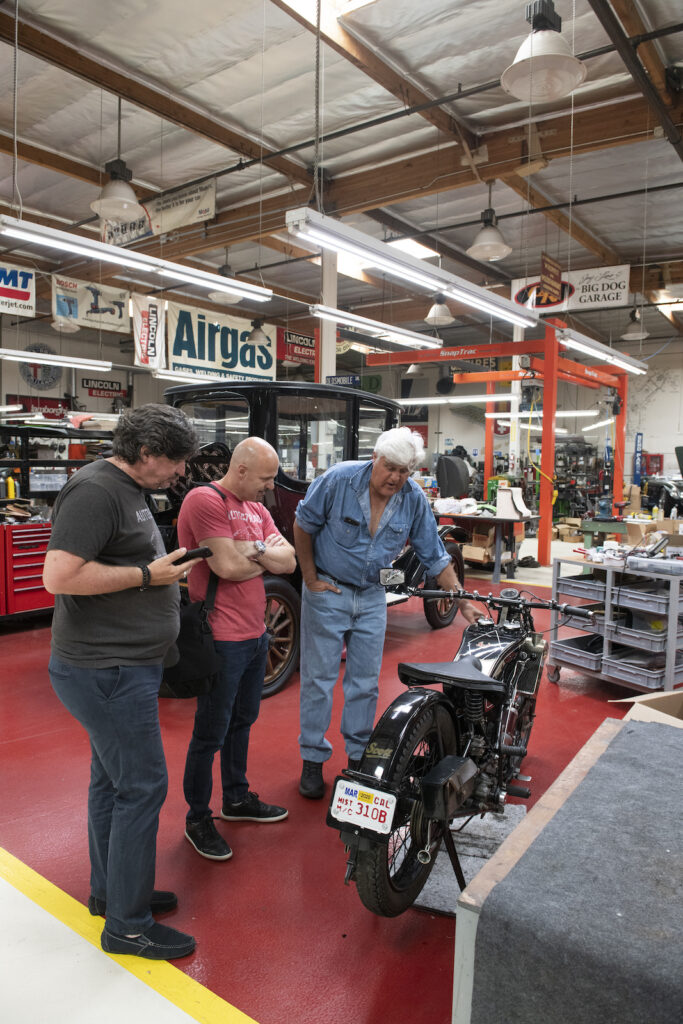 Autostrada publisher Sean Patrick and contributing writer Michael Buccioni with Jay Leno in garage car collection.