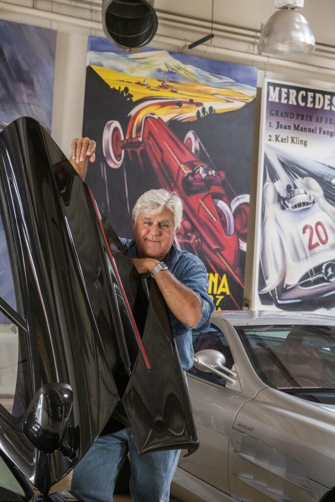 Jay Leno opening car door in garage