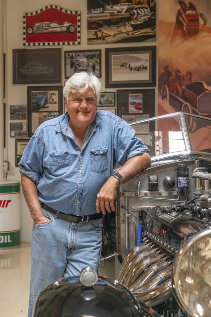 Jay Leno portrait beside vintage car