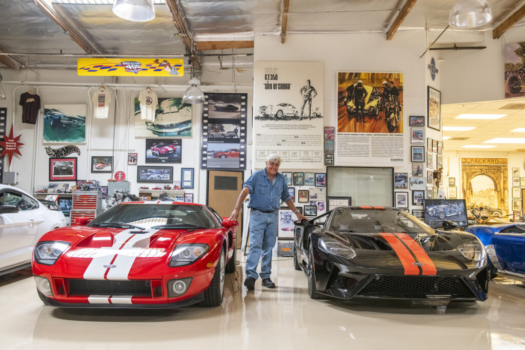 Jay Leno with Ford GT and supercars in garage