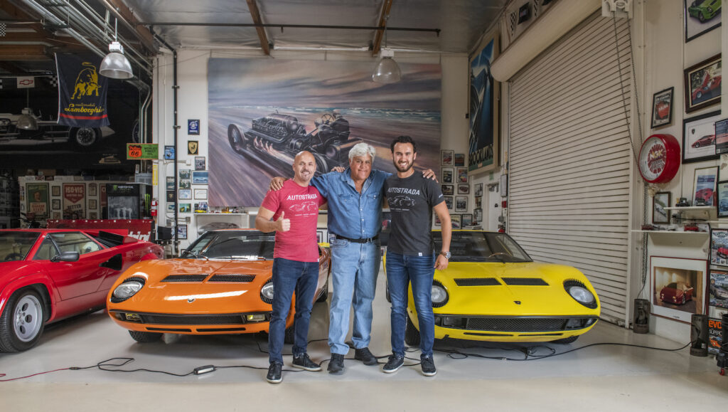Jay Leno in his garage with Autostrada Publishers Sean Patrick and Lucas Scarfone in his garage.