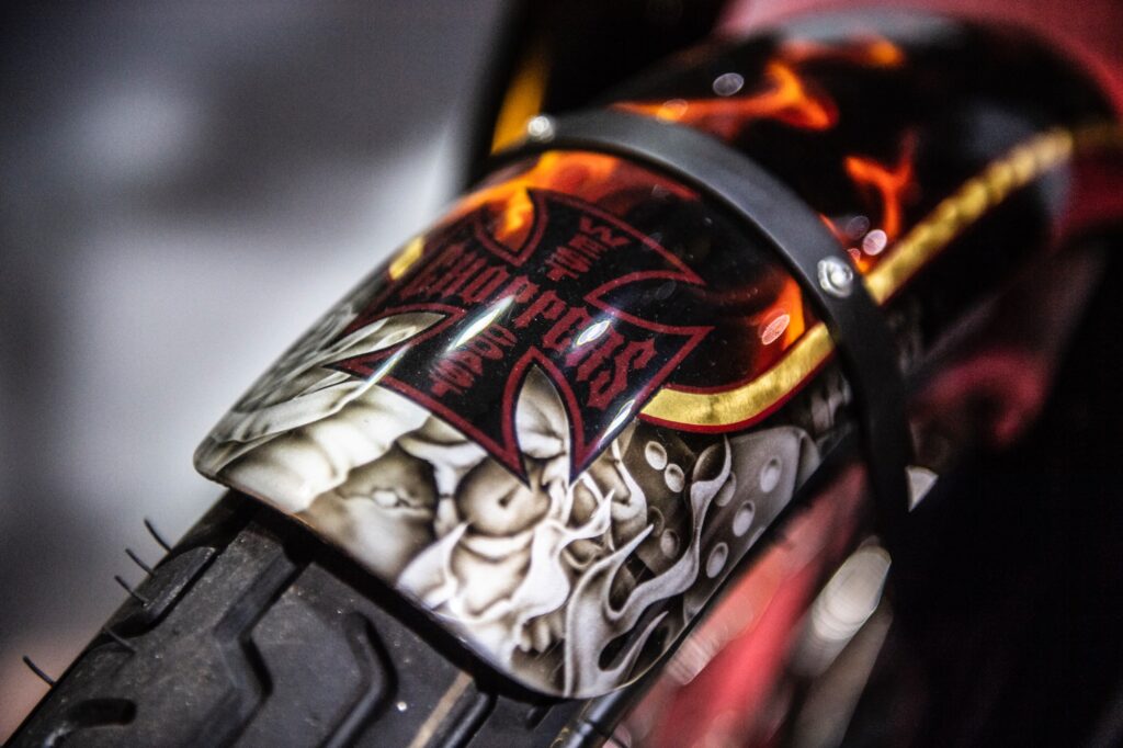Airbrushed skull and iron cross artwork on custom motorcycle fender