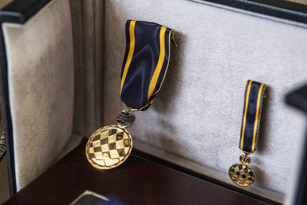 Mario Andretti racing medals displayed in a case
