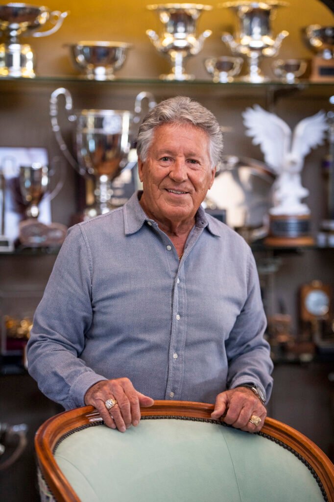 Portrait of Mario Andretti in his trophy room