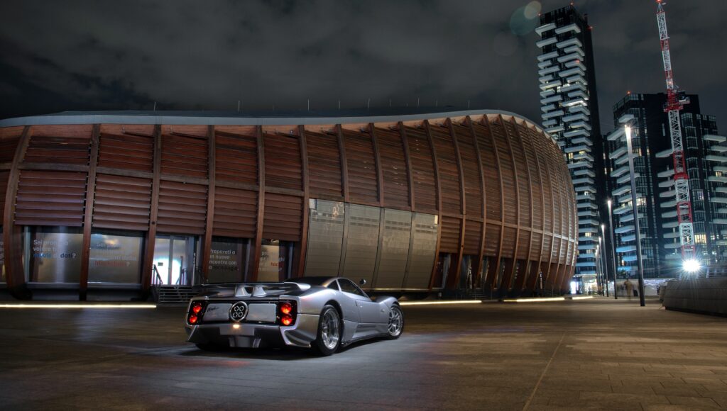 Motion shot of a Pagani Utopia hypercar travelling through an urban environment.