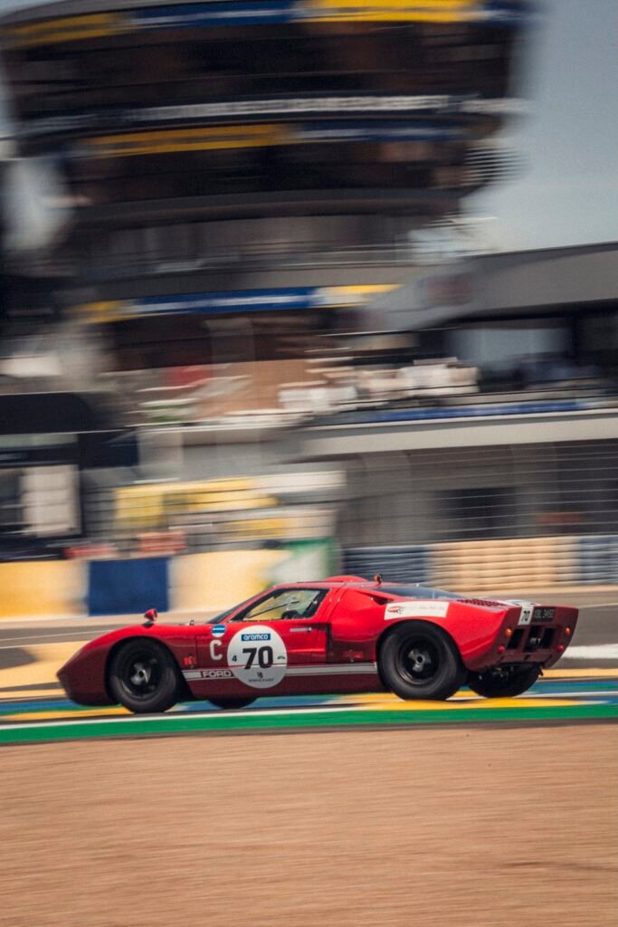Red Ford GT40 race car on track at Peter Auto Classic Le Mans