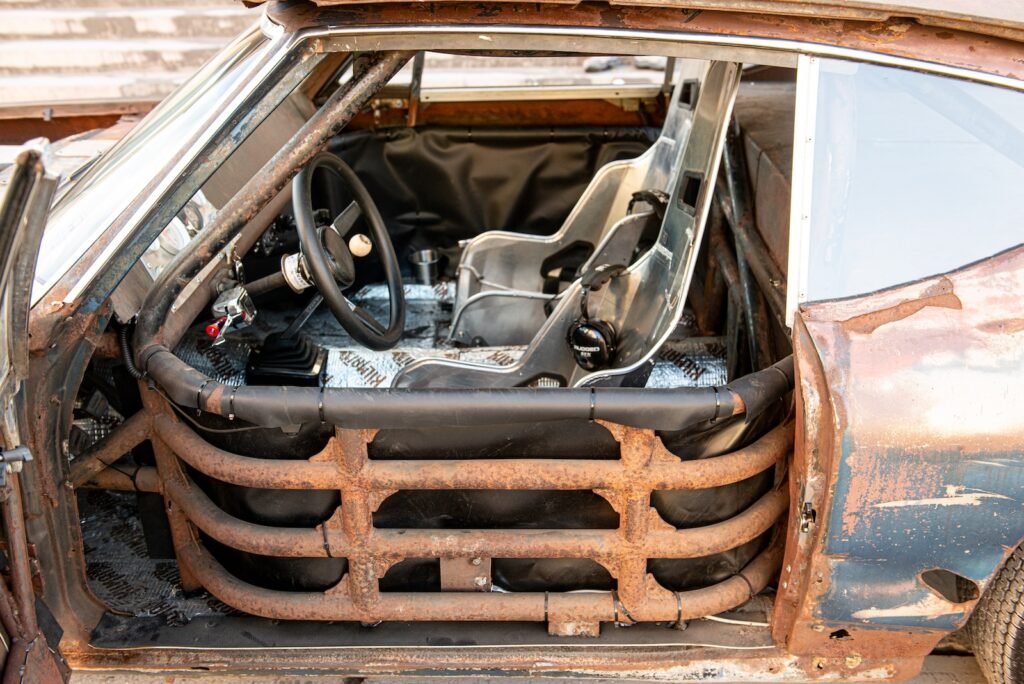 Rear roll cage bars and stripped interior structure inside Chevelle race car