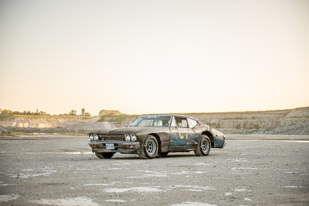 Three-quarter front view of vintage Chevrolet Chevelle race car on gravel