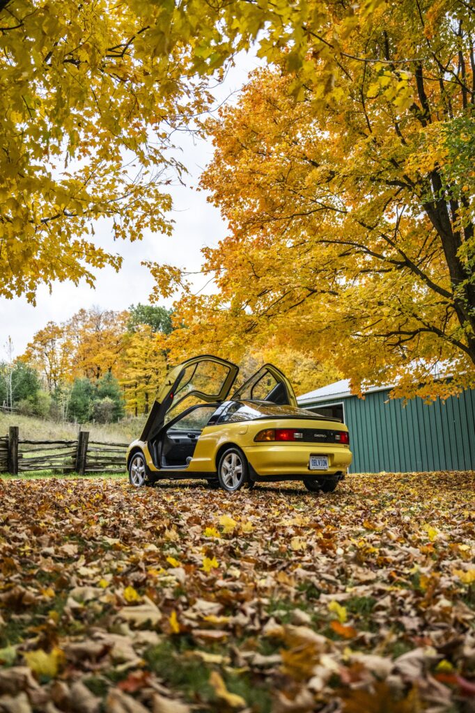 Toyota Sera parked under autumn trees rear three-quarter view