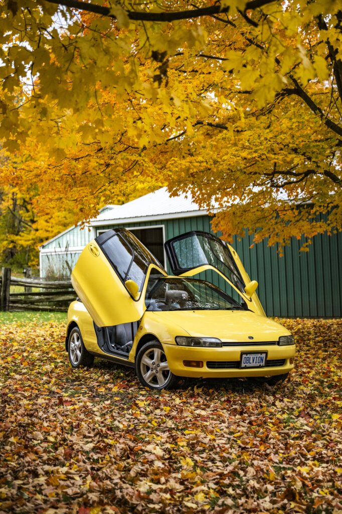 Yellow Toyota Sera front three-quarter view with butterfly door open