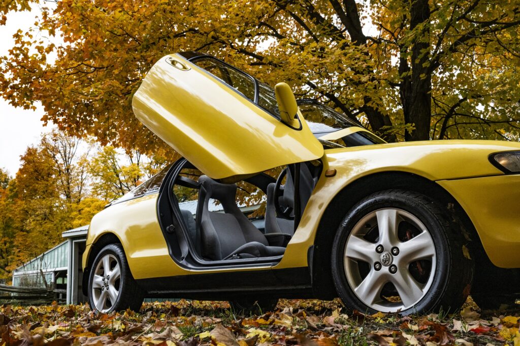 Yellow Toyota Sera side profile with butterfly door open
