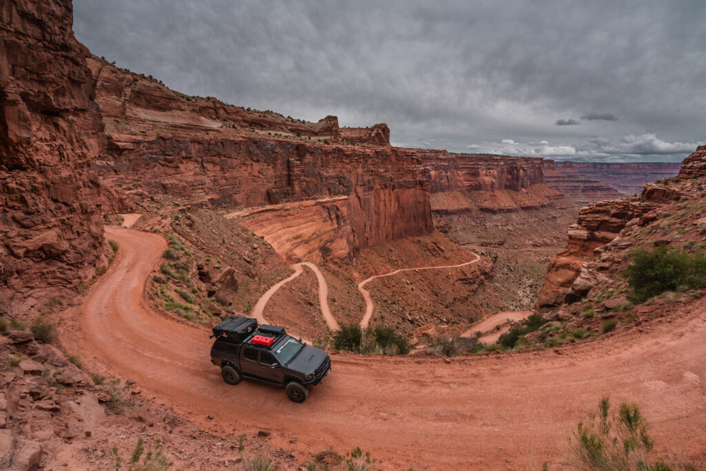 Toyota Tacoma navigating red rock canyon switchbacks in Utah