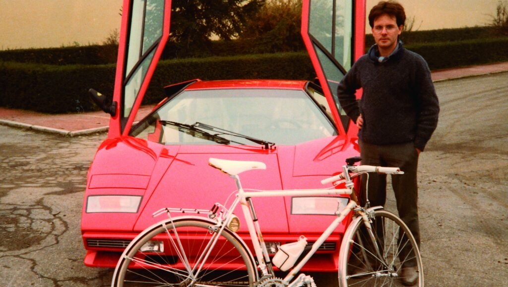 Young Horacio Pagani with red Lamborghini Countach and bicycle