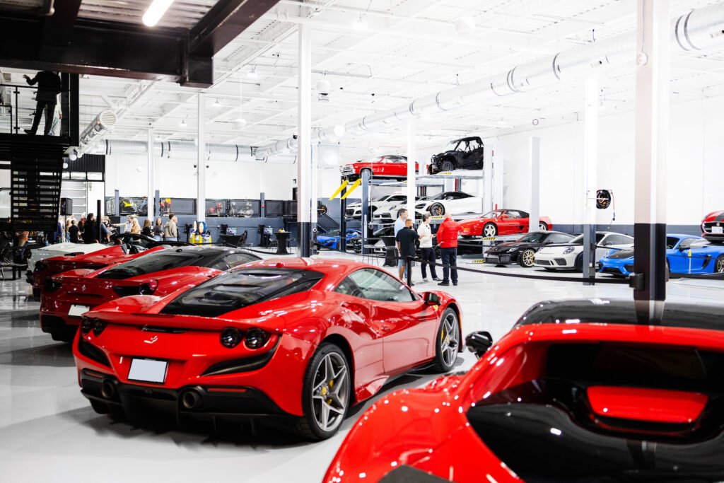 Interior of Sudbury’s 363 Car & Social Club with Ferraris, Porsches and other performance cars displayed throughout the bright, climate-controlled space.